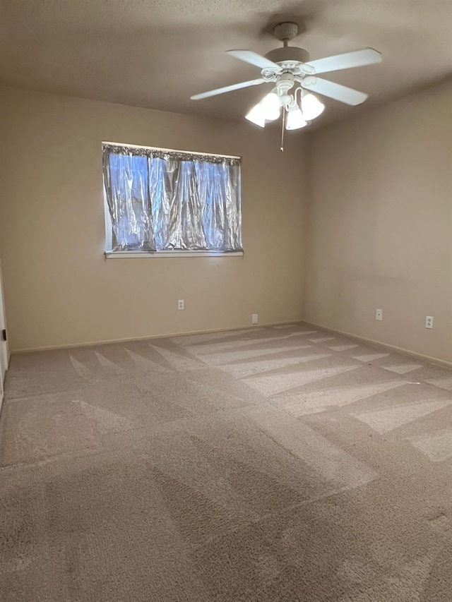 empty room with carpet floors, a textured ceiling, and ceiling fan