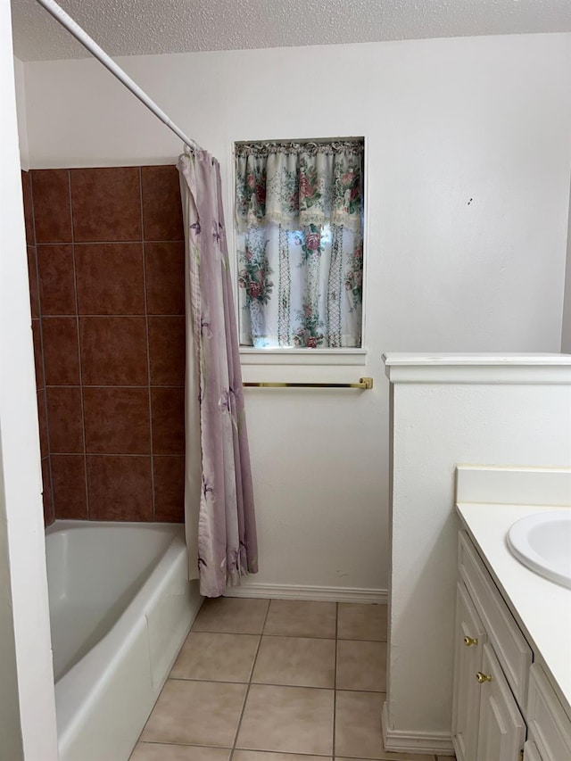 bathroom featuring shower / tub combo with curtain, vanity, tile patterned flooring, and a textured ceiling