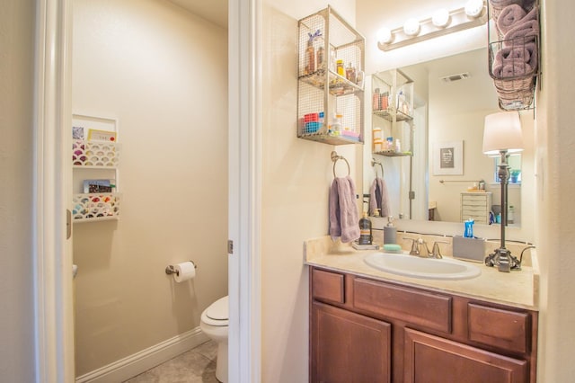 bathroom with tile patterned floors, toilet, and vanity