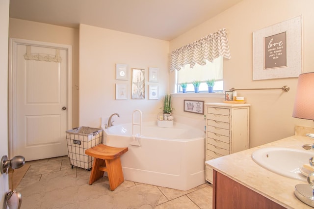 bathroom featuring a tub to relax in, tile patterned flooring, and vanity