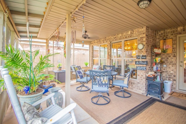 sunroom / solarium featuring a wood stove