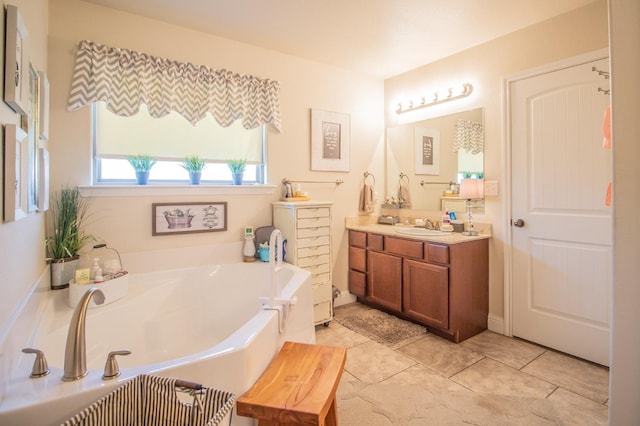 bathroom with vanity, tile patterned flooring, and a bathtub