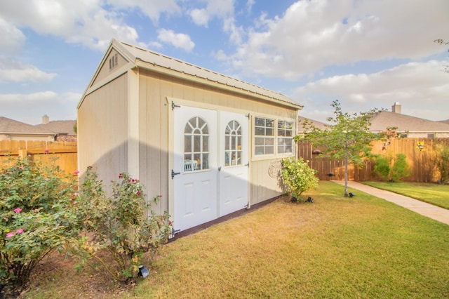 view of outbuilding with a yard