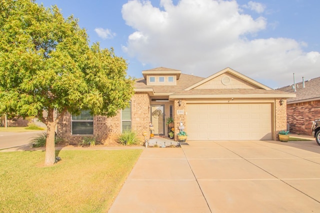 view of front of house with a garage and a front lawn