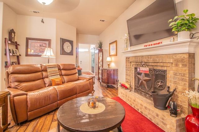 living room featuring a fireplace and light hardwood / wood-style flooring