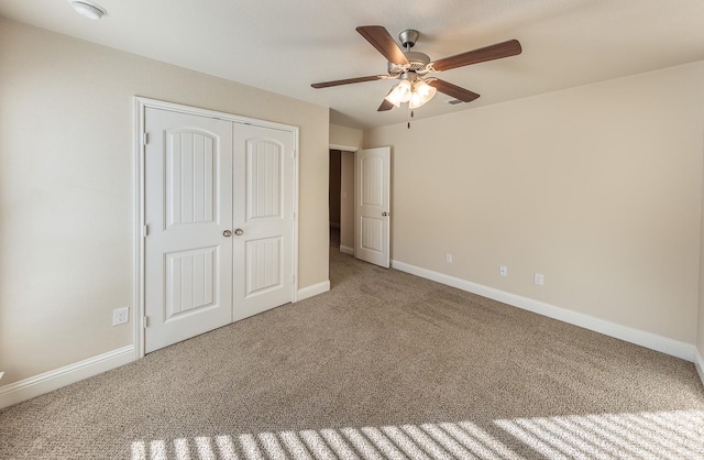 unfurnished bedroom featuring ceiling fan, carpet floors, and a closet