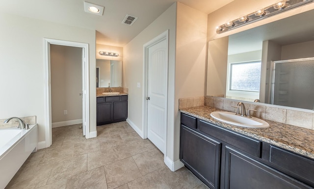 bathroom featuring vanity, shower with separate bathtub, and tile patterned floors