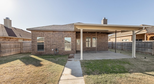 back of house featuring a yard and a patio