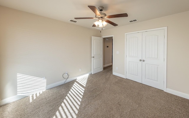 unfurnished bedroom with carpet flooring, ceiling fan, and a closet