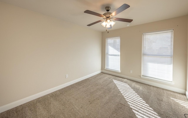 carpeted spare room with ceiling fan