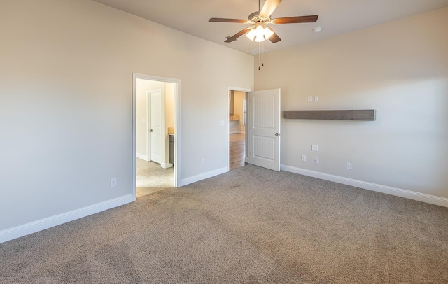 carpeted spare room featuring ceiling fan