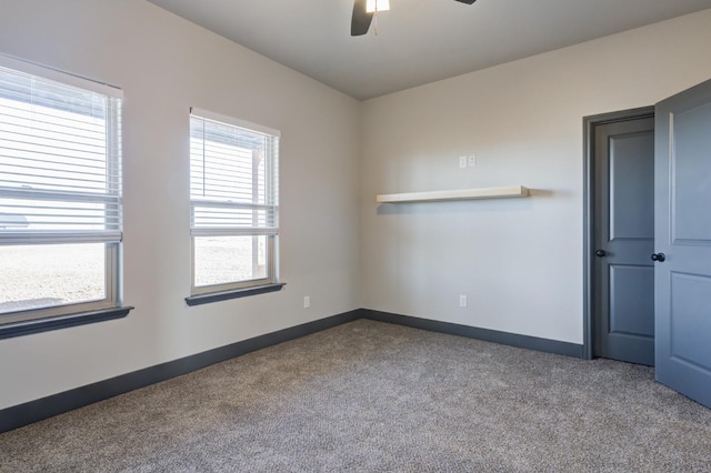 unfurnished room with ceiling fan and carpet