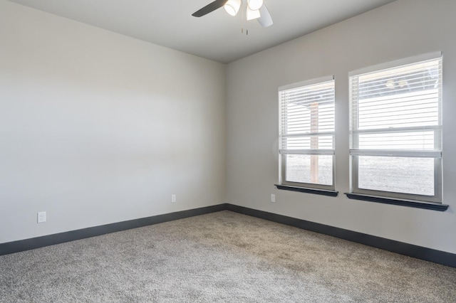 unfurnished room with light colored carpet and ceiling fan