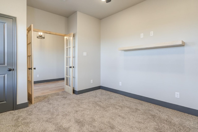 carpeted empty room featuring french doors