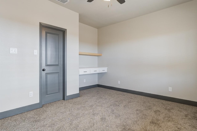 unfurnished bedroom featuring ceiling fan and light colored carpet