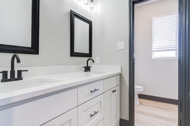 bathroom featuring vanity, hardwood / wood-style floors, and toilet