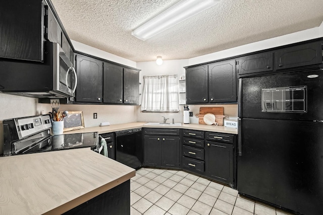 kitchen featuring sink, black appliances, a textured ceiling, and light tile patterned flooring