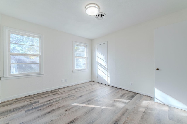 unfurnished room with light wood-type flooring