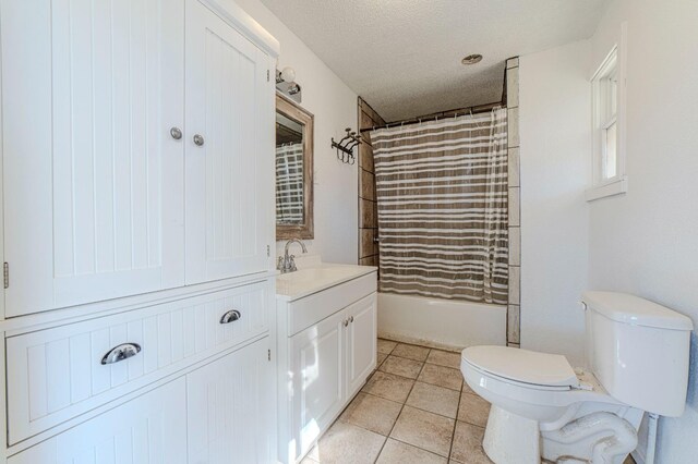 full bathroom with shower / bath combo, tile patterned flooring, vanity, a textured ceiling, and toilet