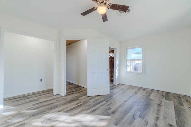 unfurnished room featuring vaulted ceiling, ceiling fan, and light wood-type flooring