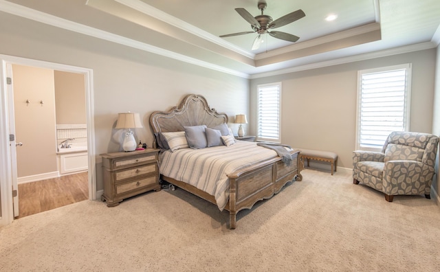 4403 103rd St, Lubbock, TX 79424 - carpeted bedroom featuring a tray ceiling, crown molding, baseboards, a ceiling fan, and ensuite bath