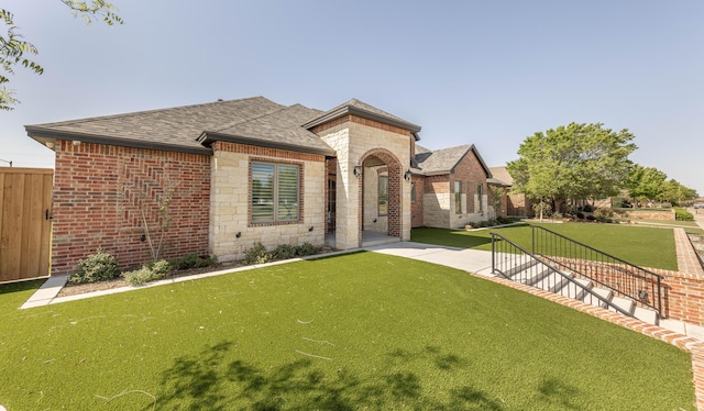 4403 103rd St, Lubbock, TX 79424 - view of front of house with roof with shingles, brick siding, and stone siding