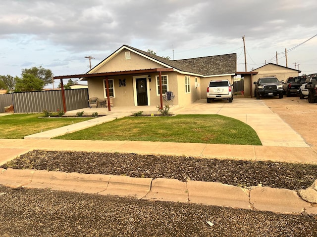 view of front of home featuring a garage, a front lawn, and covered porch