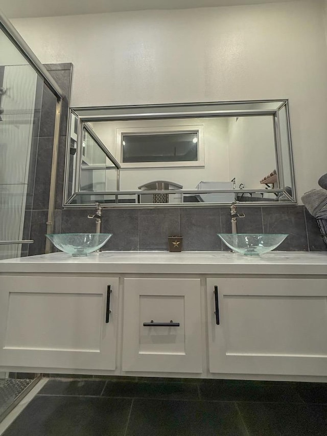 bathroom with tasteful backsplash, vanity, and walk in shower