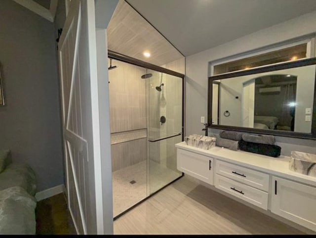 bathroom featuring vanity and an enclosed shower