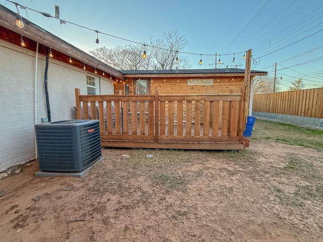 view of yard featuring a wooden deck and central AC