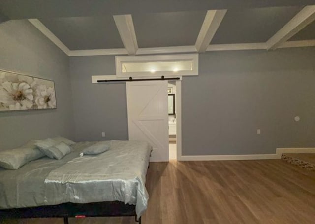 bedroom featuring hardwood / wood-style flooring, a barn door, and beam ceiling