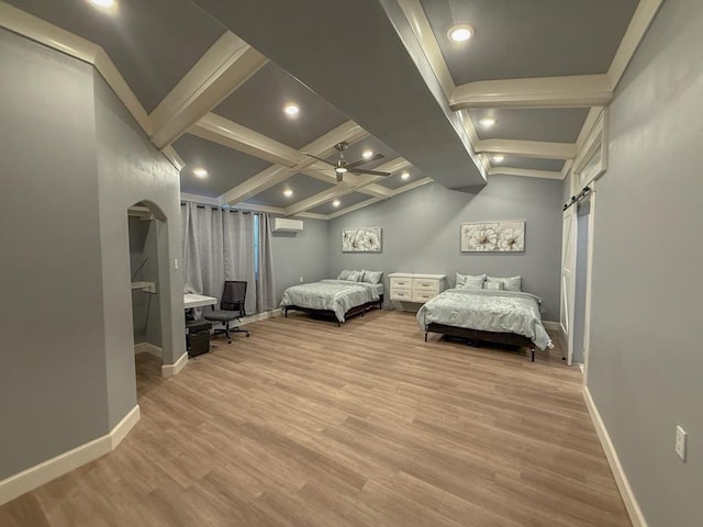 bedroom with light hardwood / wood-style flooring, beam ceiling, a wall mounted AC, coffered ceiling, and a barn door