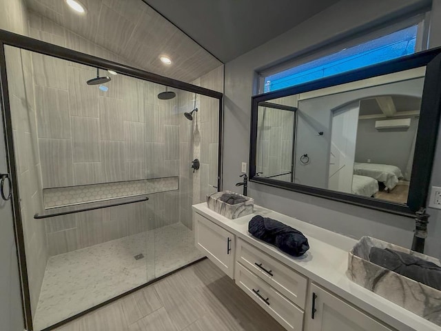 bathroom featuring vanity and an enclosed shower