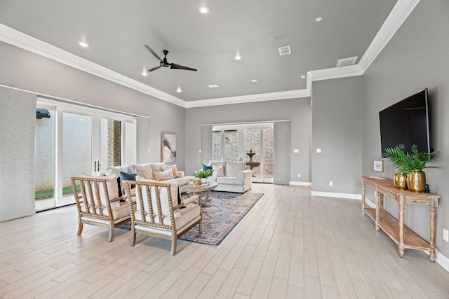 living room featuring ceiling fan, ornamental molding, and light hardwood / wood-style floors