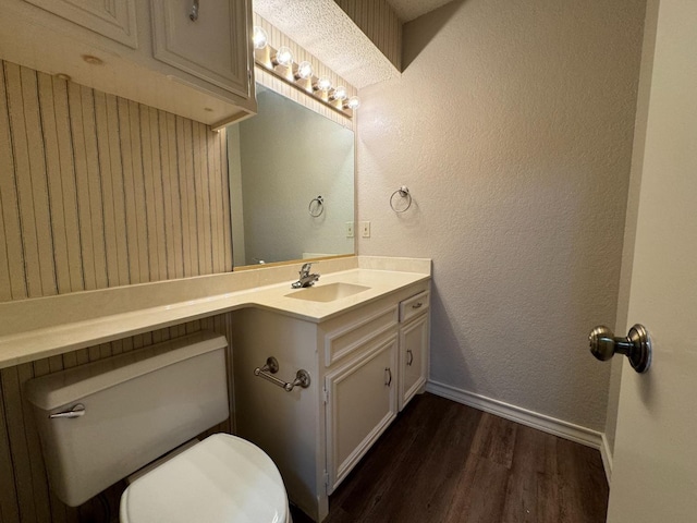 bathroom with vanity, hardwood / wood-style floors, and toilet