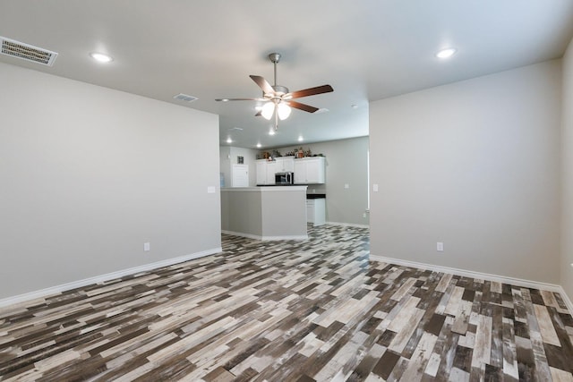 unfurnished living room featuring wood-type flooring and ceiling fan