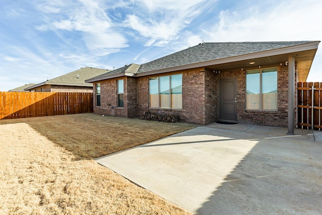 back of house with a patio and a yard