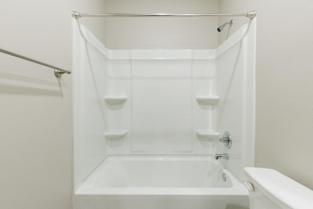 bathroom featuring shower / bathtub combination and toilet