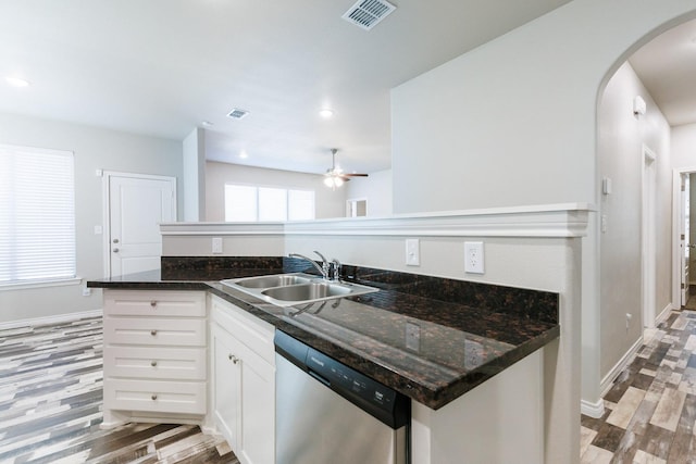 kitchen with white cabinetry, sink, dark stone counters, and dishwasher