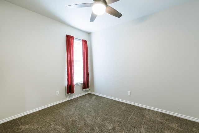 unfurnished room with ceiling fan and dark carpet