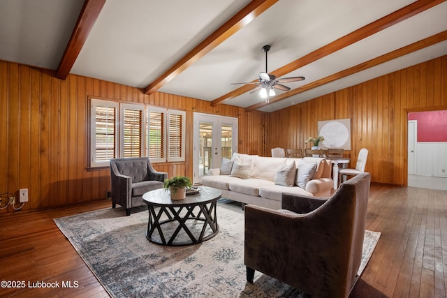 2005 32nd St, Lubbock, TX 79411 - living area with hardwood / wood-style floors, a ceiling fan, healthy amount of natural light, and wooden walls