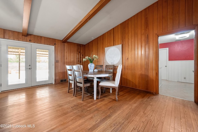 2005 32nd St, Lubbock, TX 79411 - dining room featuring wooden walls, french doors, and light wood-type flooring