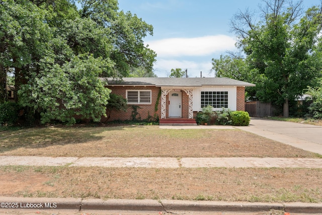2005 32nd St, Lubbock, TX 79411 - view of front facade featuring brick siding and driveway