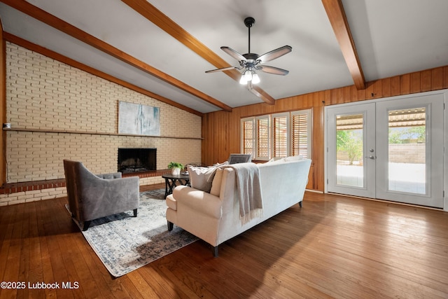 2005 32nd St, Lubbock, TX 79411 - living room featuring hardwood / wood-style floors, brick wall, ceiling fan, french doors, and a fireplace