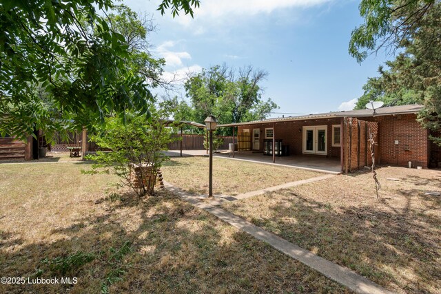 2005 32nd St, Lubbock, TX 79411 - view of yard with french doors and a patio area