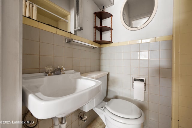 2005 32nd St, Lubbock, TX 79411 - bathroom featuring tile walls, toilet, a shower with curtain, and a sink