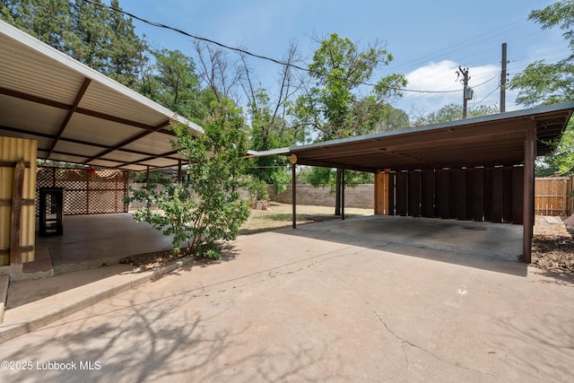 2005 32nd St, Lubbock, TX 79411 - view of parking featuring driveway and a carport