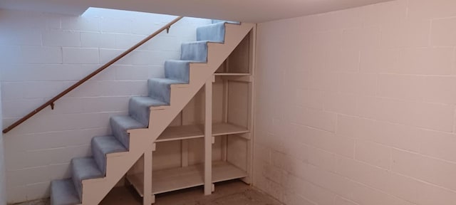 stairway featuring concrete flooring