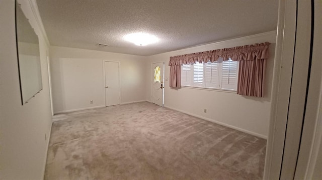 spare room with carpet floors and a textured ceiling