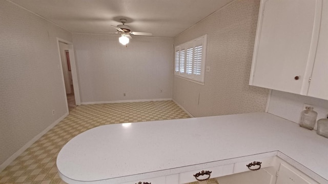 kitchen with white cabinetry and ceiling fan